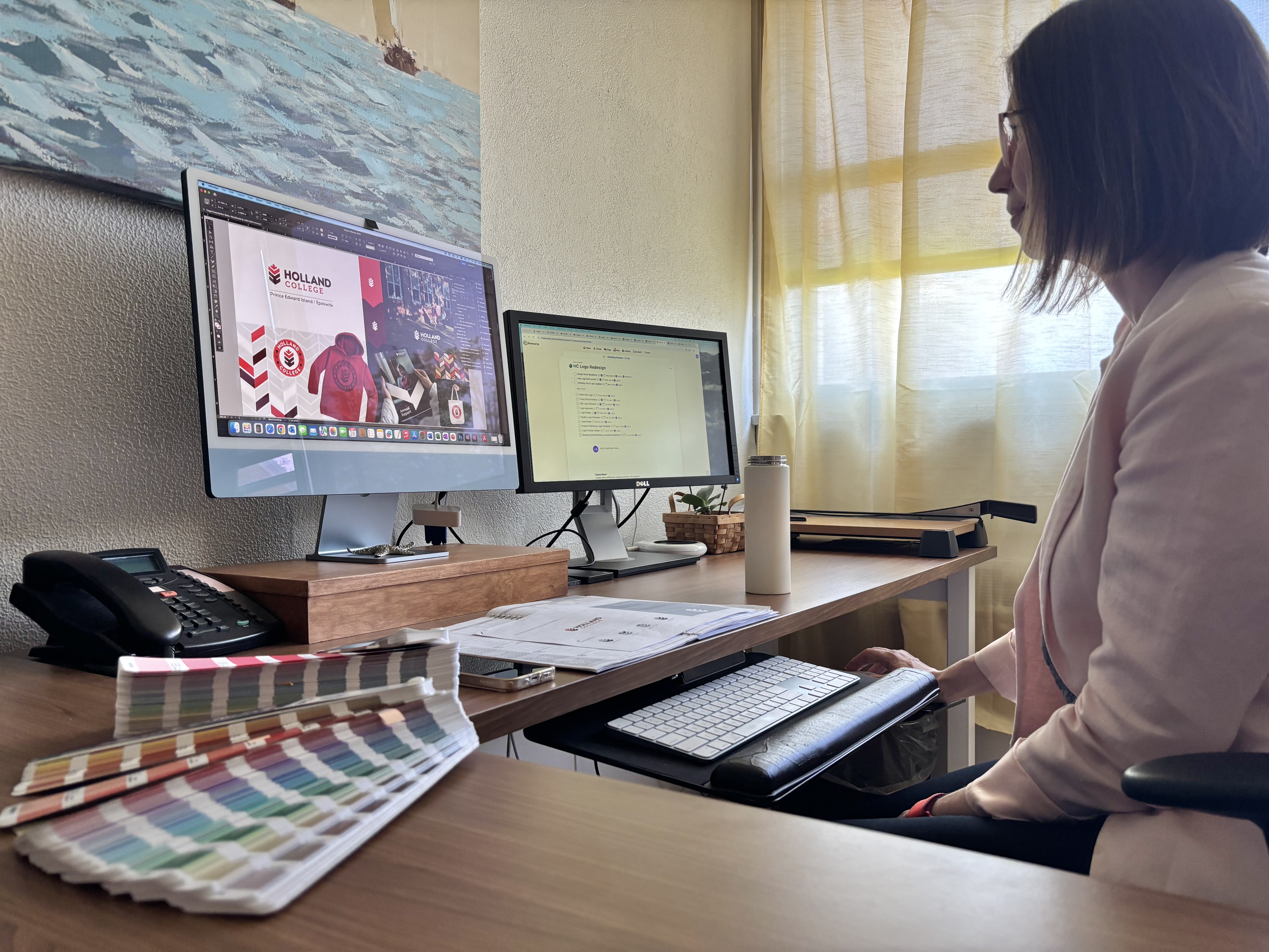lisa stapleton works on the logo deisgn on her computer