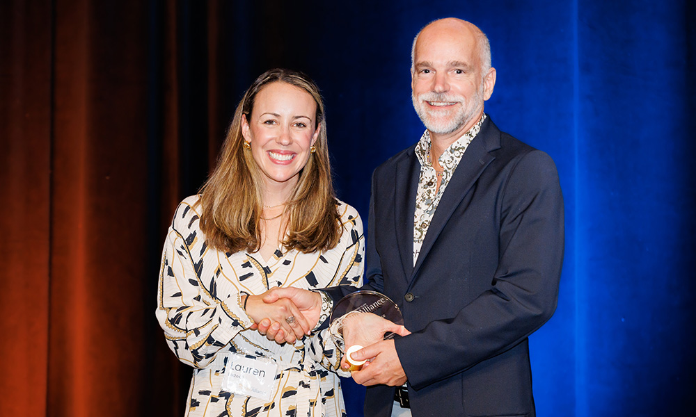 Lauren Ledwell shaking hands with Dr. Mike Gibson