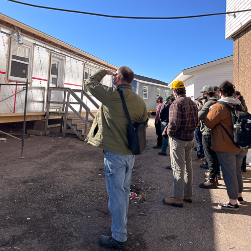 Students from Charlottetown Rural tour the carpentry cottage build underway at the Summerside Waterfront Campus.