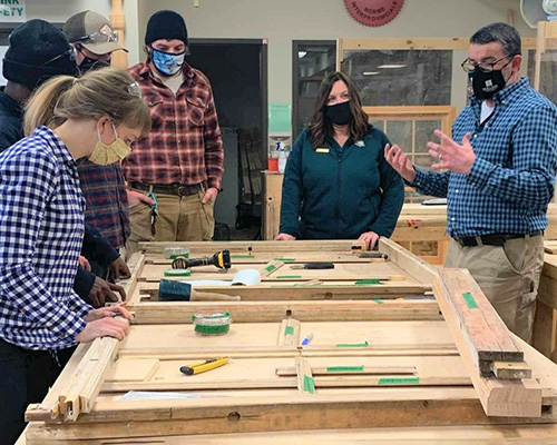 Parks Canada Project Manager, Nicolle Gallant visits with students in the Heritage Retrofit Carpentry Shop 