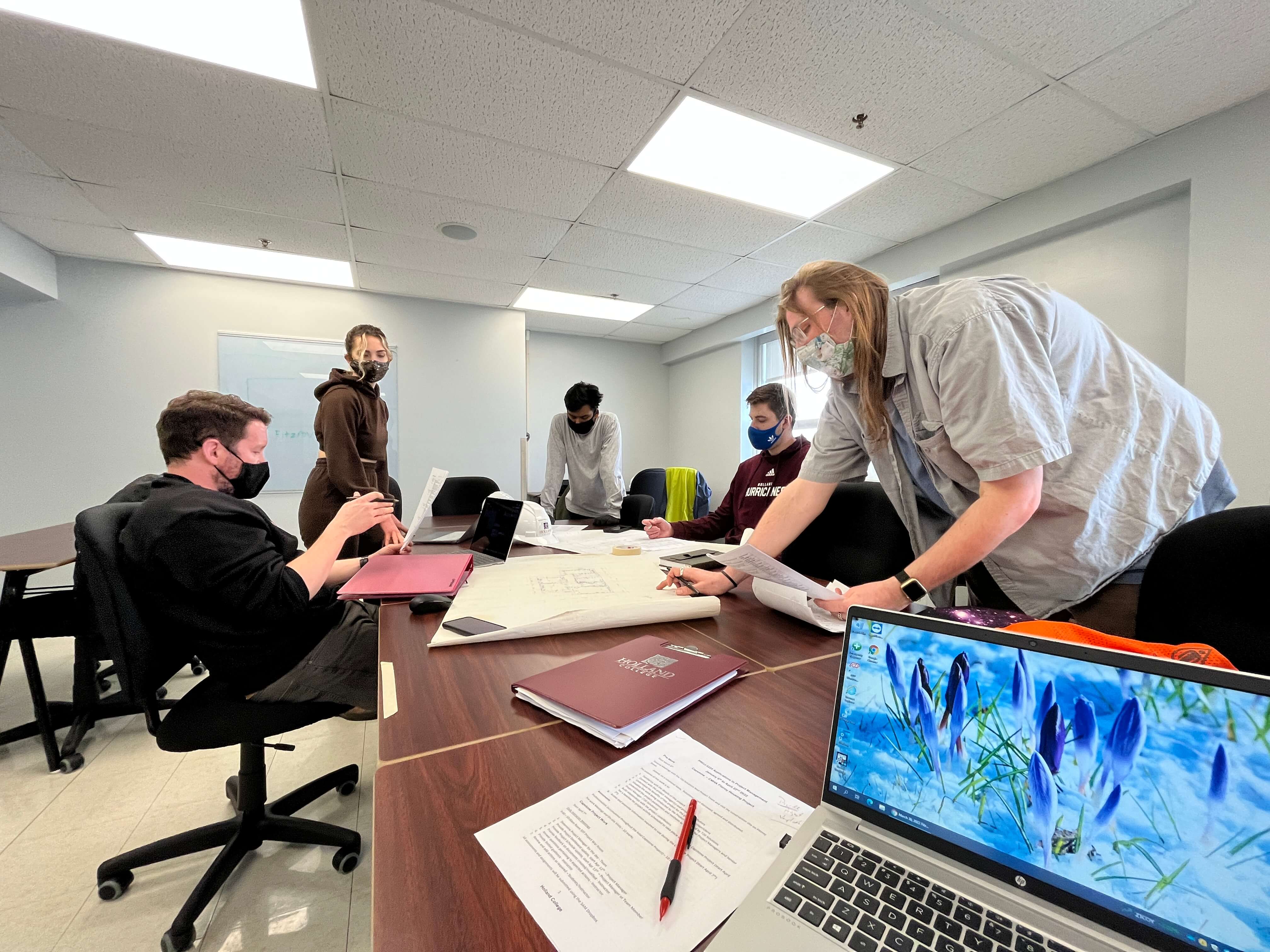 students discuss the next project phase during a class meeting