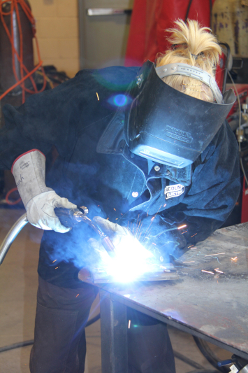 Student welding in lab